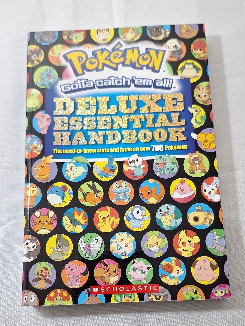 Scholastic Pokémon Deluxe Essential Handbook - Black, Gold, Blue